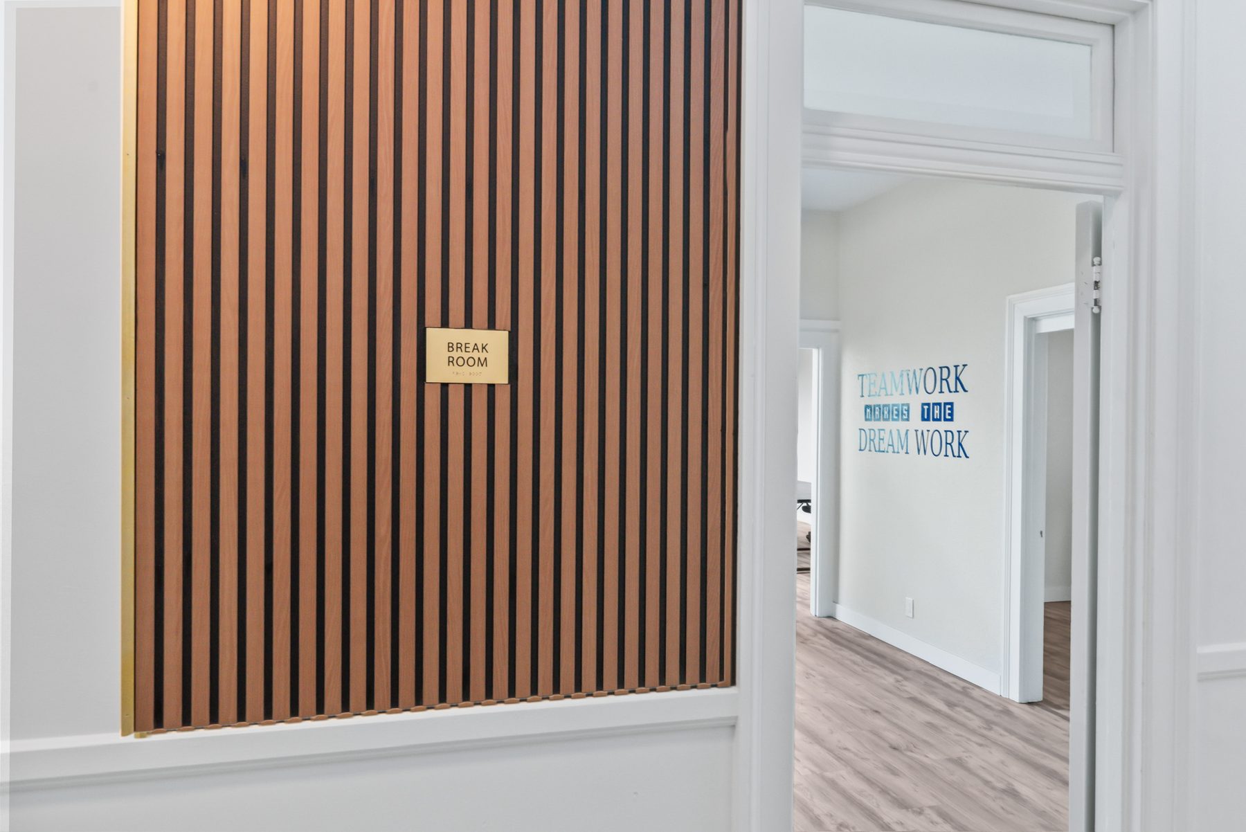 Break room with wood-slat feature wall